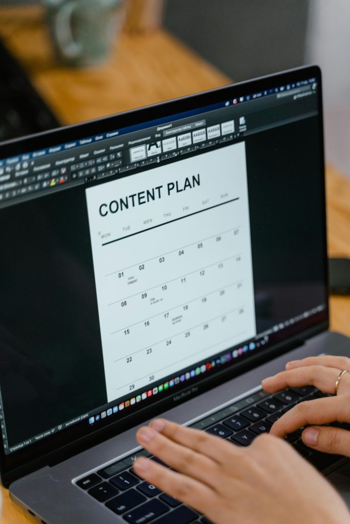 ABC(M)s for Central Florida Small Businesses - Always Be Content Marketing! Close-up of hands typing on a laptop displaying a content plan document, ideal for business or marketing content.